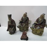 3 glazed clay oriental deity figurines and small stone figurine, 1 as found. Estimate £20-40.