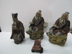 3 glazed clay oriental deity figurines and small stone figurine, 1 as found. Estimate £20-40.