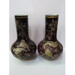 Pair of dark red bottle vases hand-painted with birds and foliage in the style of Thomas Webb,