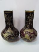 Pair of dark red bottle vases hand-painted with birds and foliage in the style of Thomas Webb,