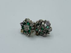 Two emerald and diamond earrings, one as found. Estimate £50-80.