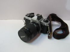 Nikon FM2 camera body and lens on an Olympus strap. Estimate £100-200.