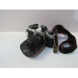 Nikon FM2 camera body and lens on an Olympus strap. Estimate £100-200.