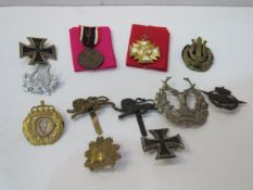 Quantity of military badges together with 2 German medals. Estimate £25-35.
