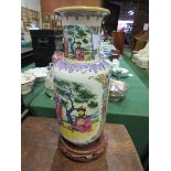 Tall rounded Chinese famille figural vase on stand. Estimate £30-50.