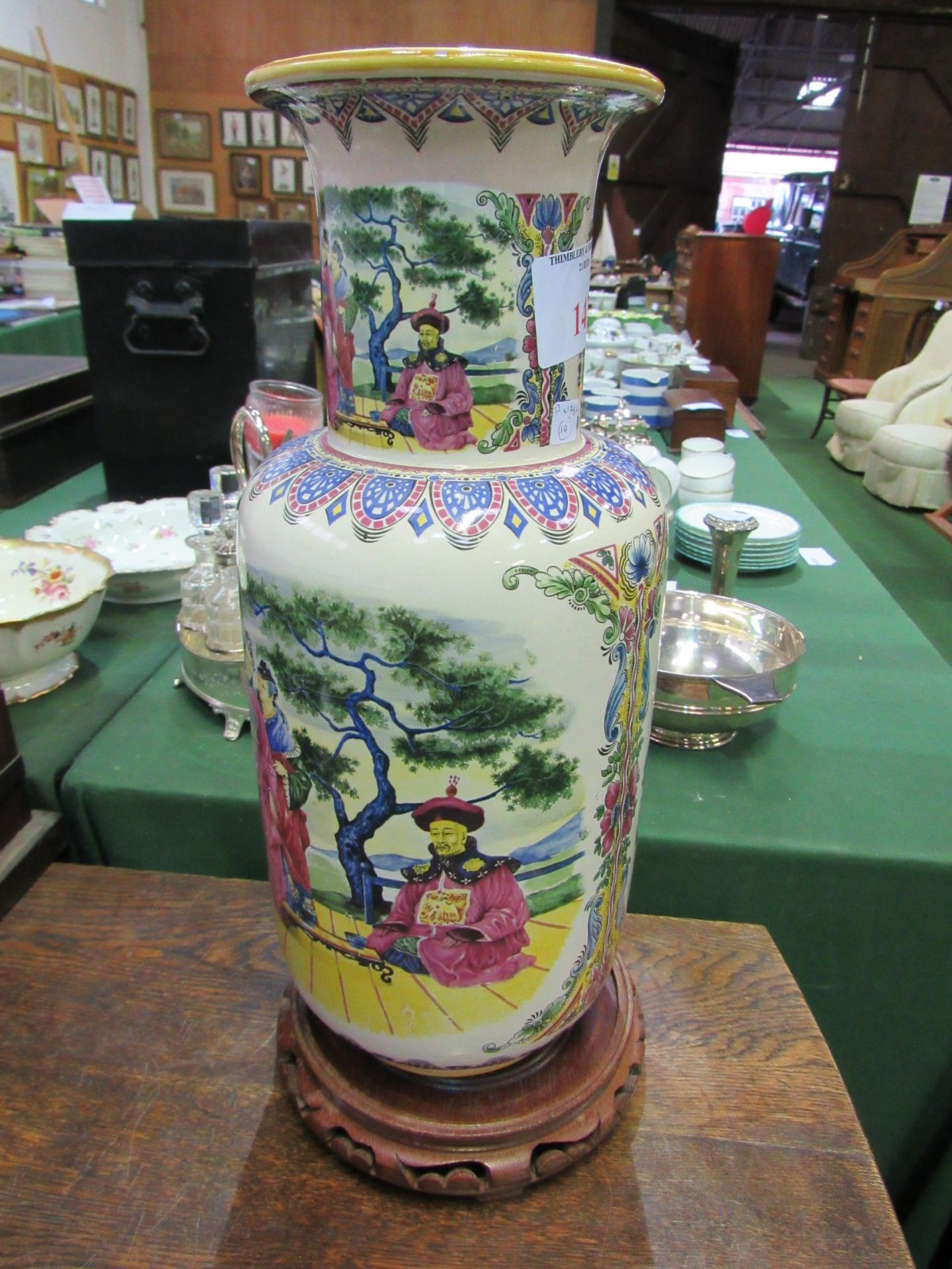 Tall rounded Chinese famille figural vase on stand. Estimate £30-50.