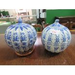 2 blue and white oriental decorative lidded jars. Height 28cms. Estimate £30-40.