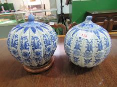 2 blue and white oriental decorative lidded jars. Height 28cms. Estimate £30-40.