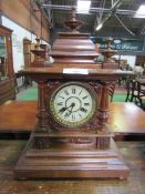 Oak case mantel clock with finial decoration. Height 52cms. Estimate £40-60.