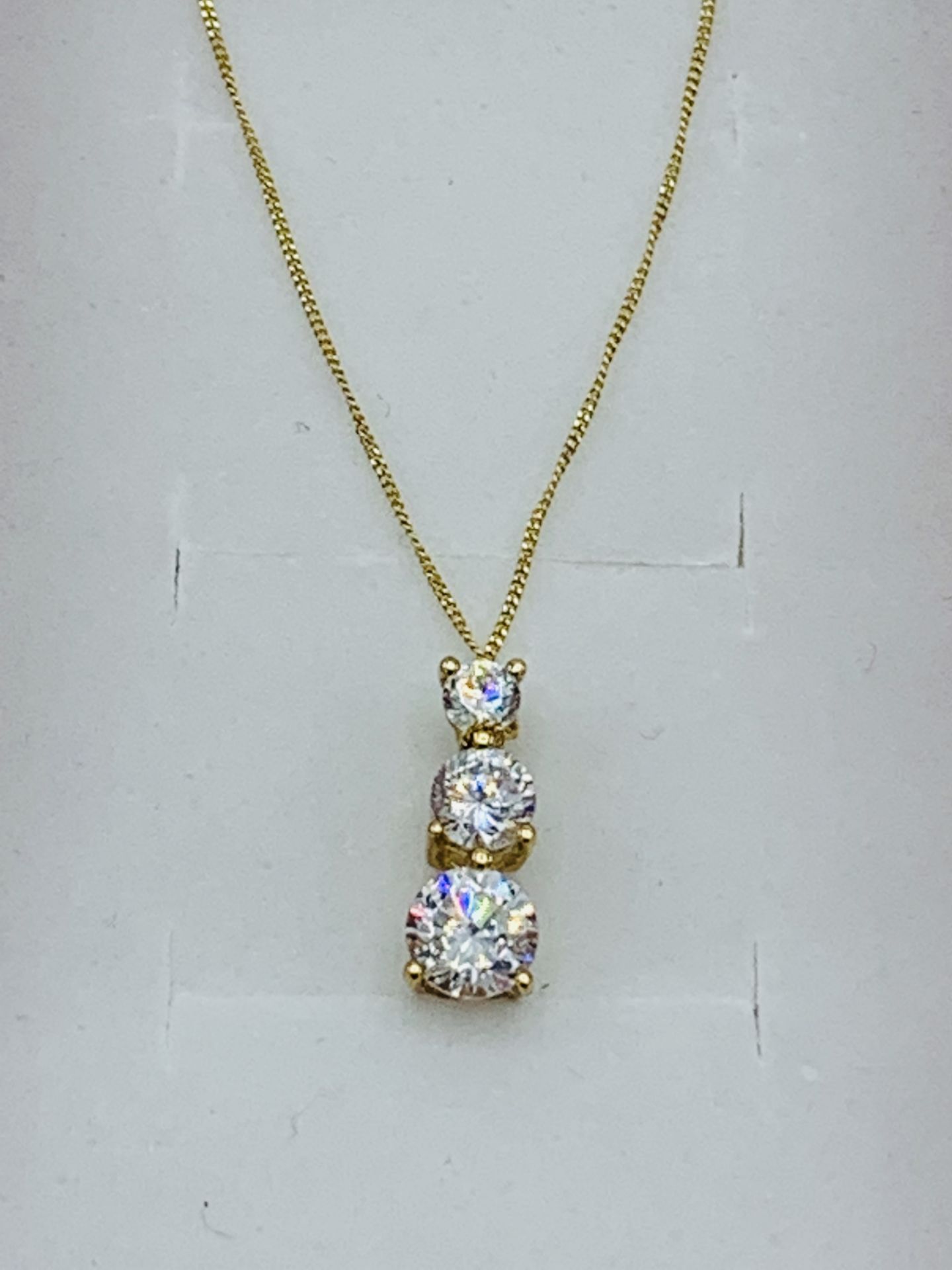 9ct gold pendant necklace set with three zircon stones. Estimate £30-40. - Image 2 of 2