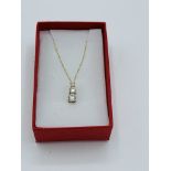 9ct gold pendant necklace set with three zircon stones. Estimate £30-40.