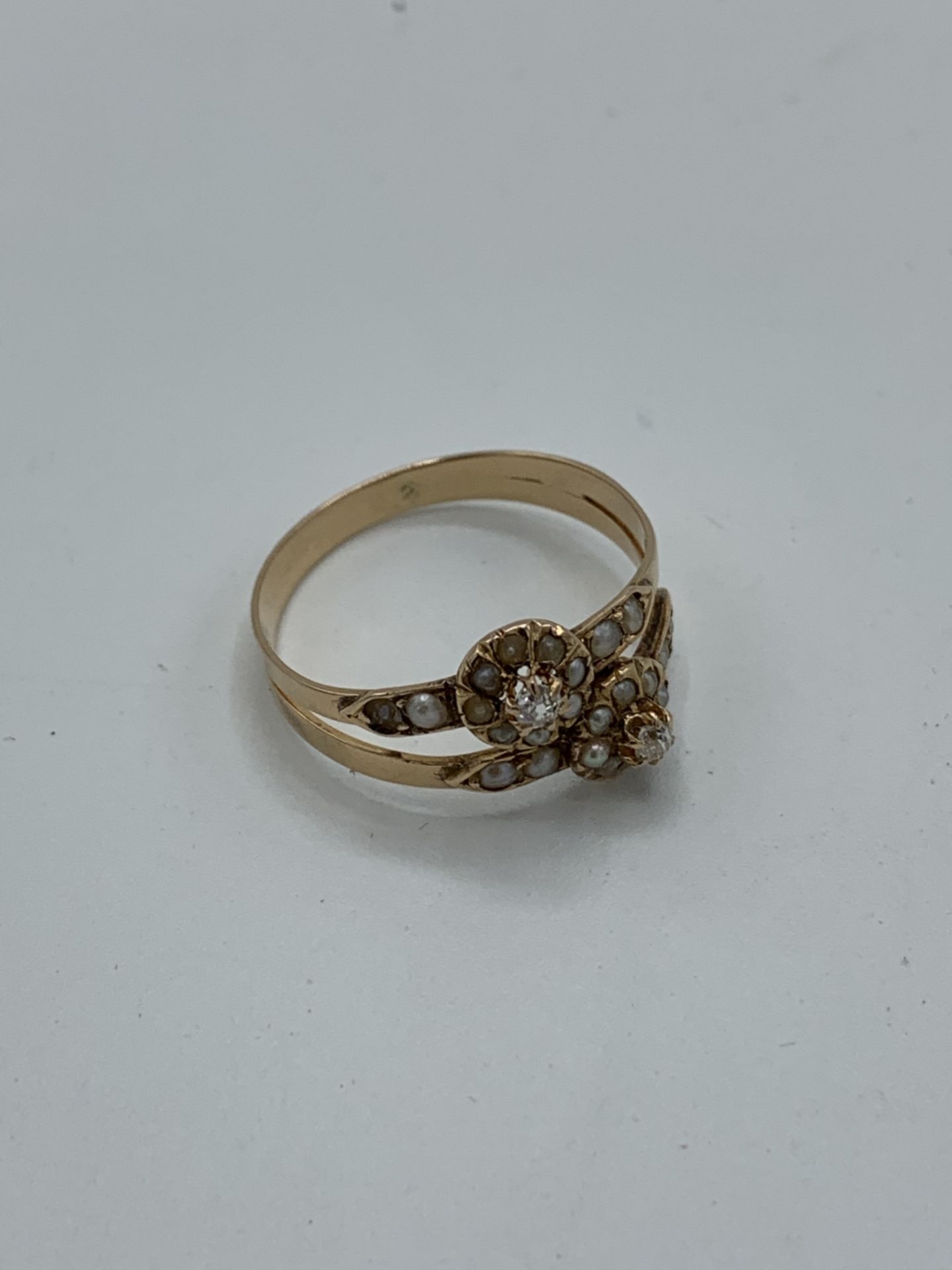 Yellow metal antique diamond and seed pearl ring, weight 2.0gms, size O. Estimate £150-200.