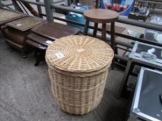 Wooden stool and a wicker laundry basket.