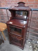 Mahogany drinks cabinet with mirror to back, part glazed front and rack beneath.