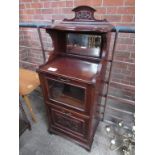 Mahogany drinks cabinet with mirror to back, part glazed front and rack beneath.