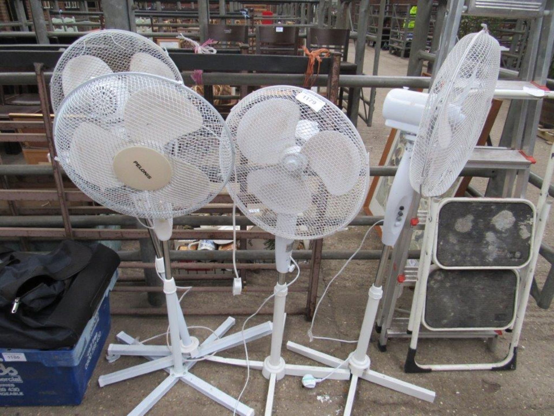 4 floor standing electric fans.