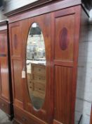 Edwardian mahogany wardrobe with oval door mirror & drawer to base, 116 x 45 x 204cms.