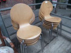 12 stackable laminated metal framed chairs.