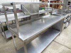 Large stainless steel preparation table with over and under shelf.