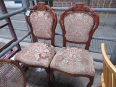 2 upholstered spoon-back chairs.