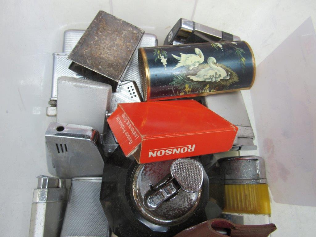 Quantity of various cigarette lighters and cases.