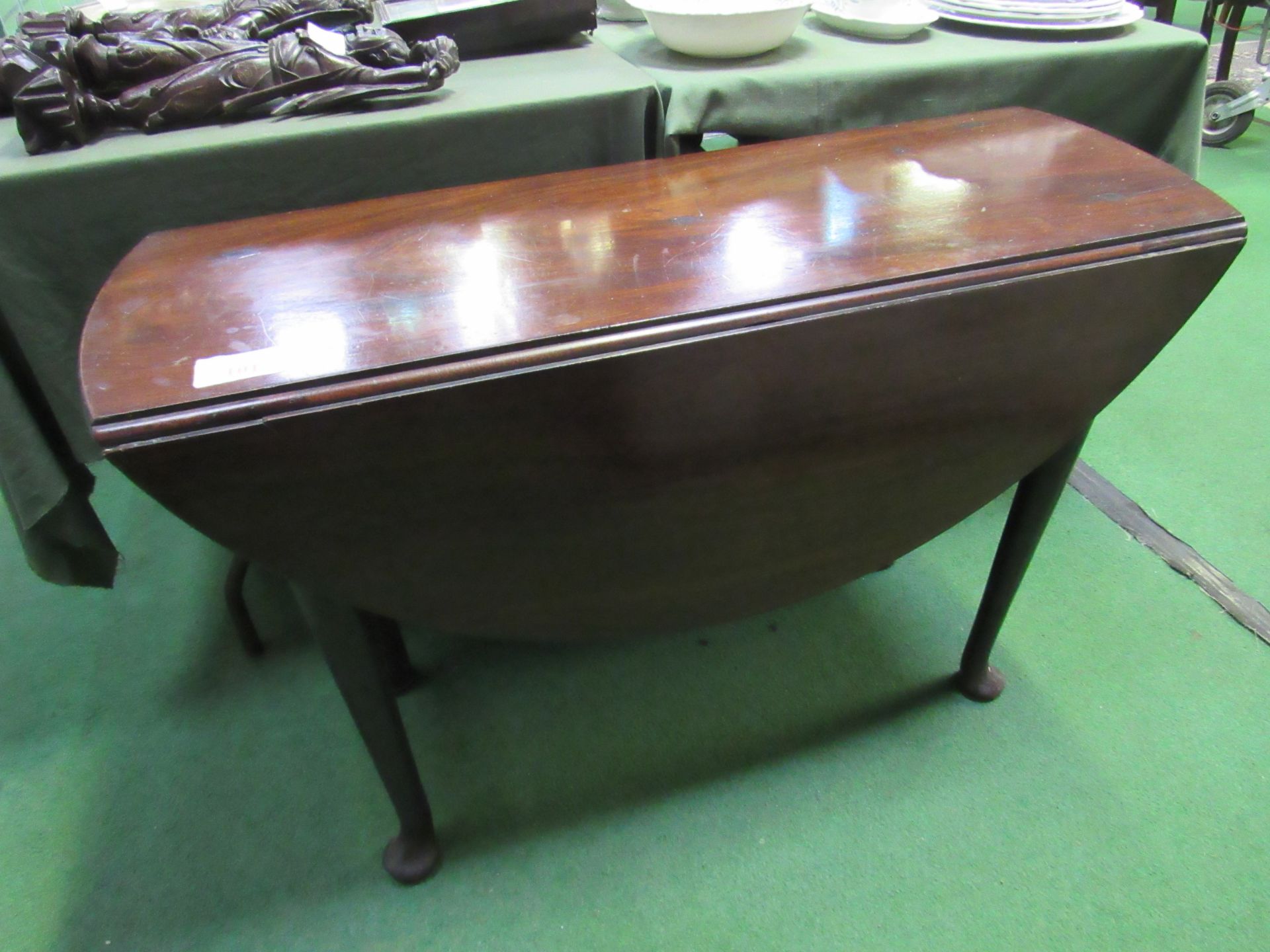 Rosewood gate leg table on pad feet.