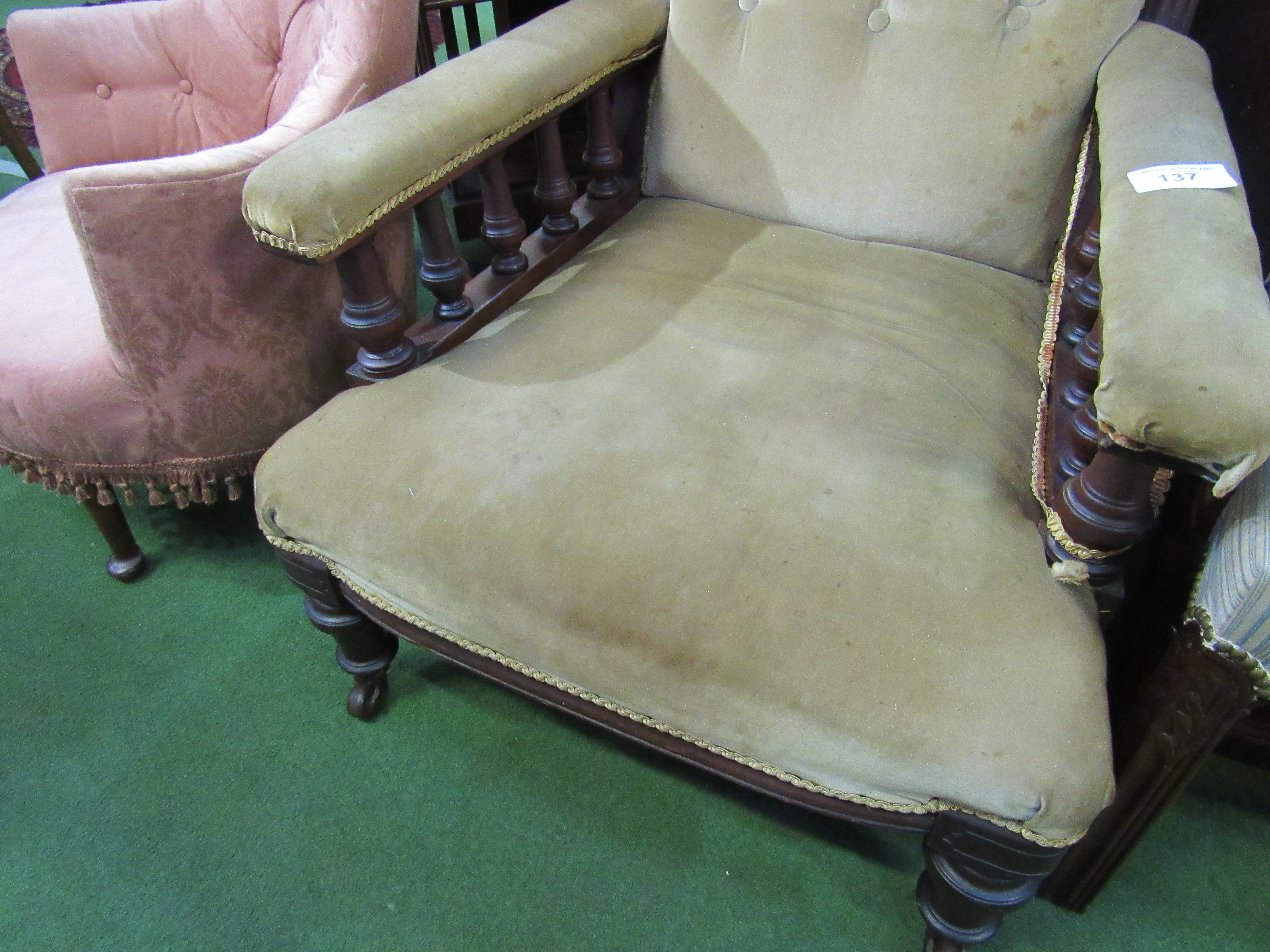 Victorian / Edwardian brown upholstered armchair on casters.