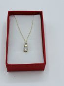 9ct gold pendant necklace set with three zircon stones.