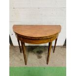 Inlaid mahogany demi-lune shaped fold-over top card table with gate leg, on tapered legs.