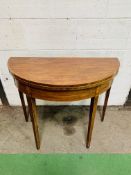 Inlaid mahogany demi-lune shaped fold-over top card table with gate leg, on tapered legs.