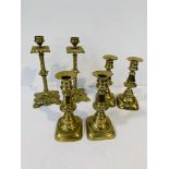 2 pairs of antique brass candlesticks, height 16.5cms; together with a pair of decorative antique br