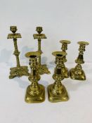 2 pairs of antique brass candlesticks, height 16.5cms; together with a pair of decorative antique br