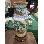 Tall rounded Chinese famille figural vase on stand.