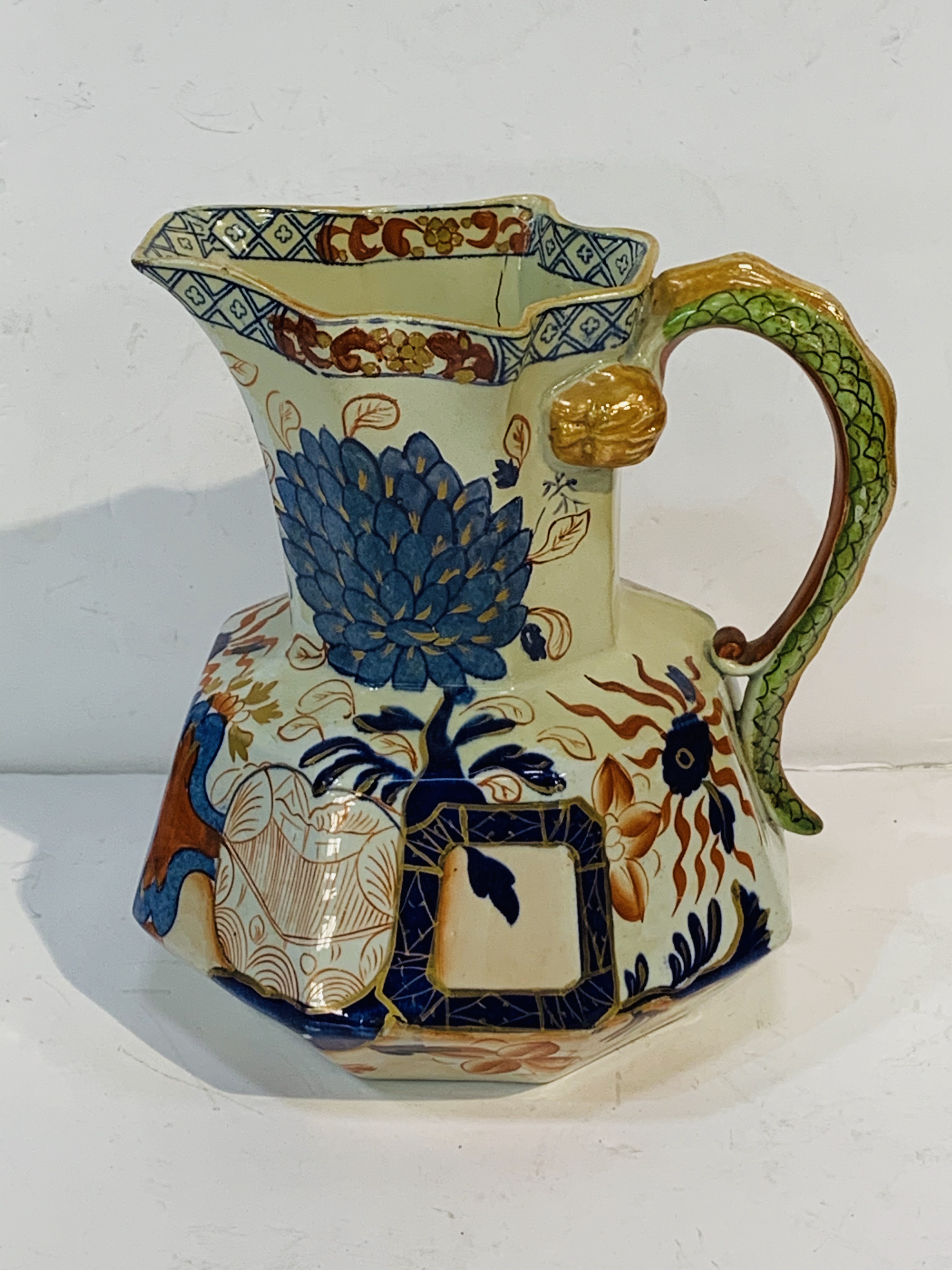 Colourful Davenport Stone China jug with serpent handle, together with a blue and white "mask" jug.