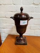 Brown lustre painted metal covered urn.