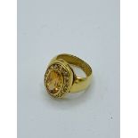 18k gold ring with large oval tawny coloured stone and diamonds