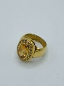 18k gold ring with large oval tawny coloured stone and diamonds