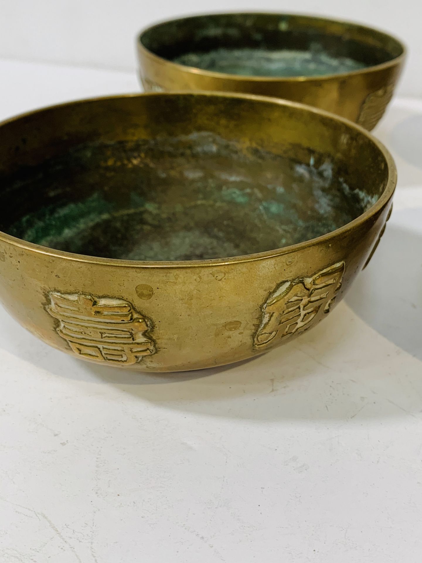 Set of 4 Chinese bronze 11.5cms bowls with Dragon design and character marks. - Image 3 of 3