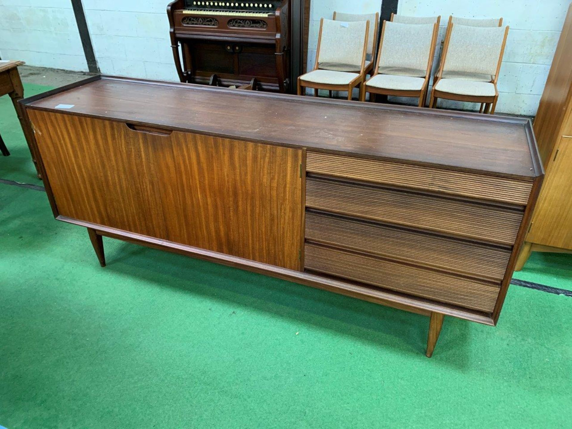 1950s teak sideboard with 2 cupboards and 4 graduated drawers.