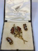 Yellow metal, diamond (1 missing) & citrine floral brooch with earrings, by Garrard of London.