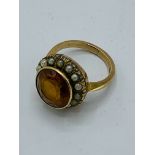 Victorian 9ct gold ring set with dark yellow stone surrounded by seed pearls