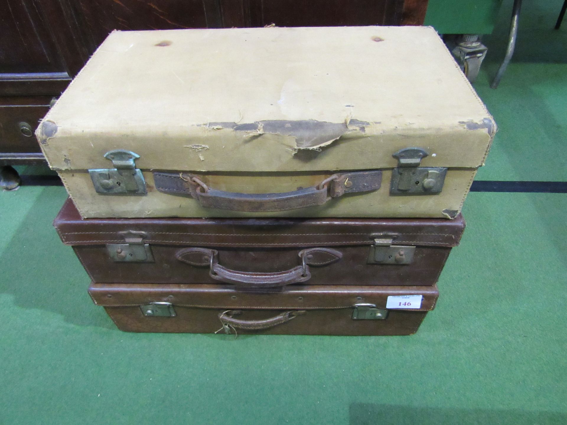 3 vintage suitcases.