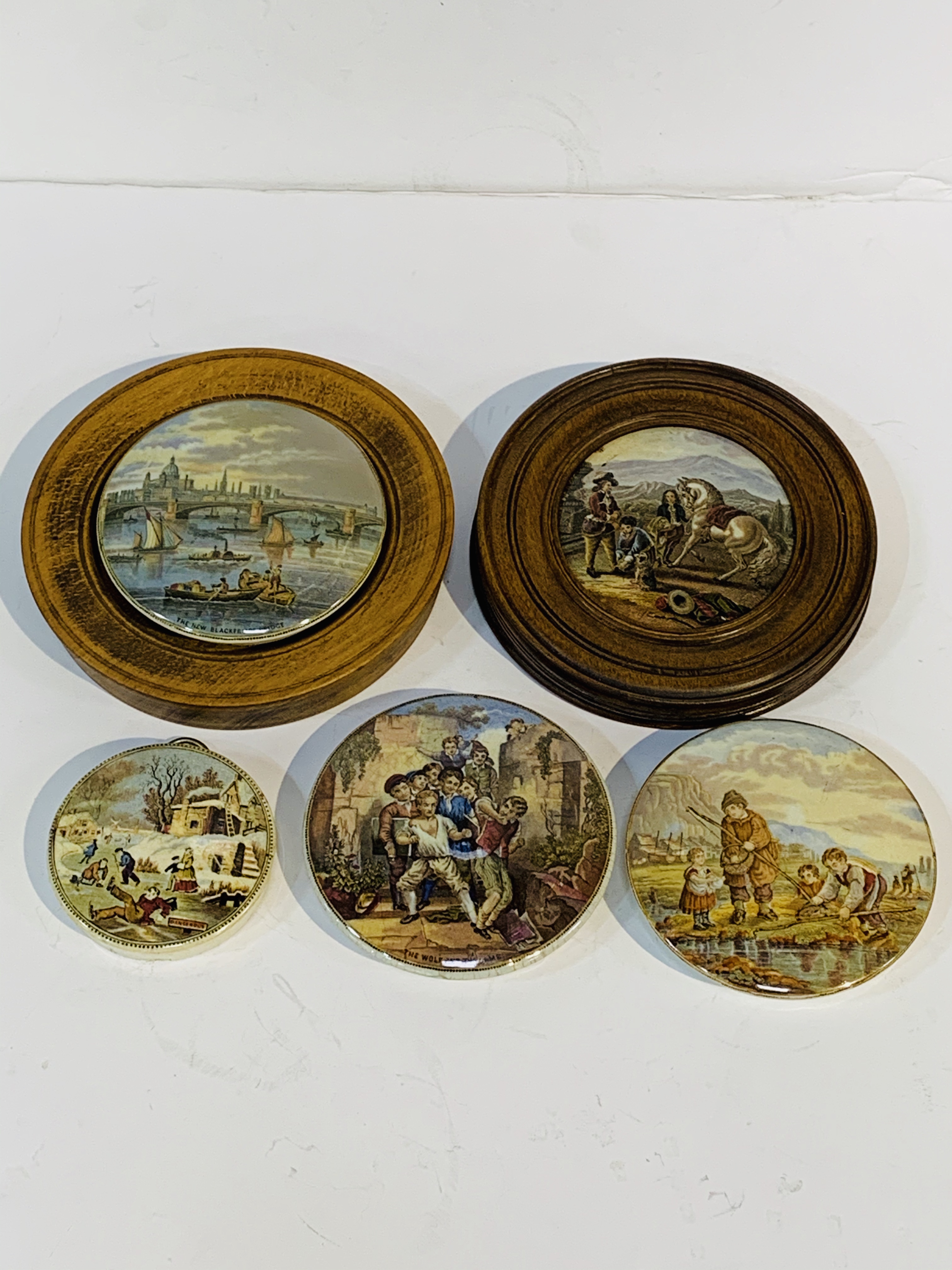 Five 19th Century pot lids 2 wooden frames