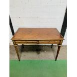 Mahogany writing table with brass decoration, 2 frieze drawers, on tapered turned supports.