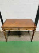 Mahogany writing table with brass decoration, 2 frieze drawers, on tapered turned supports.