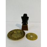 Bronze head of an Indian goddess on wooden stand; small brass tray; brass tsuba.
