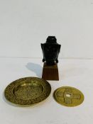 Bronze head of an Indian goddess on wooden stand; small brass tray; brass tsuba.