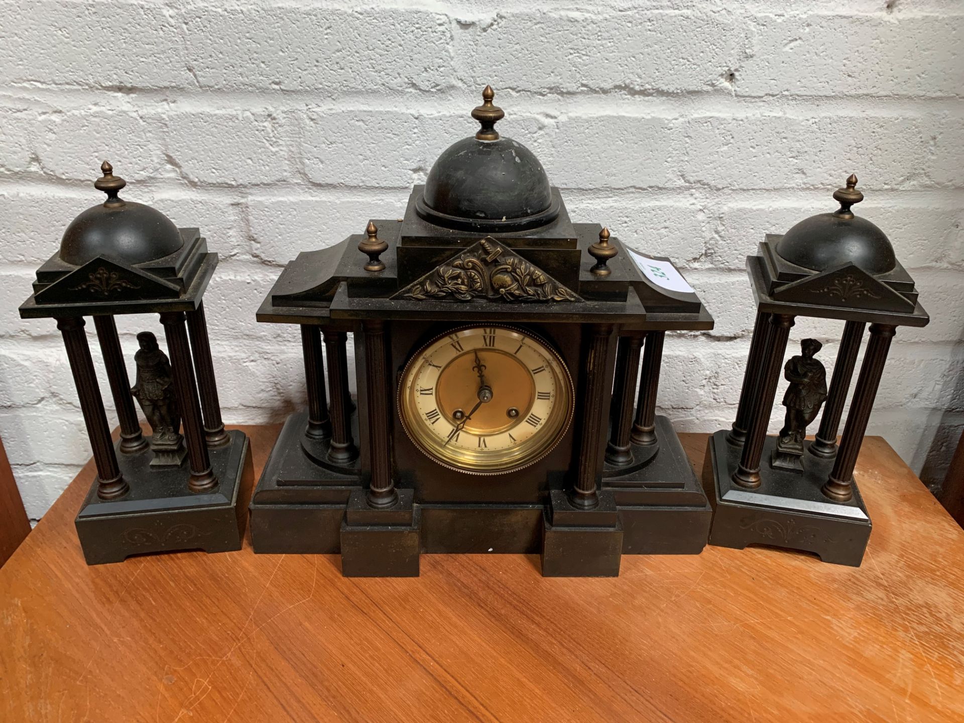 Slate clock set with two figurines garnitures.