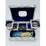 Large decorated silver coloured metal covered jewellery box containing costume jewellery