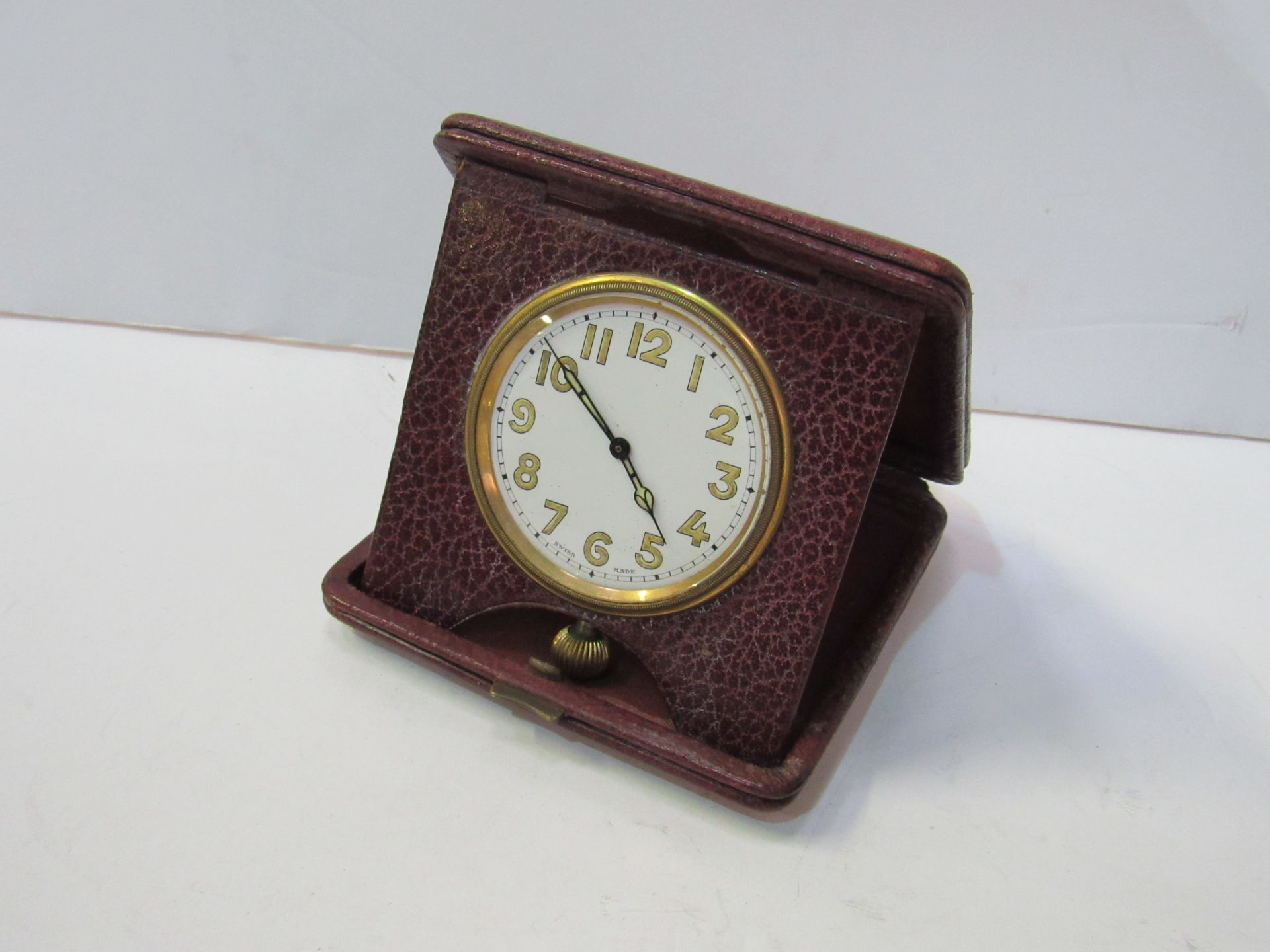 Vintage travelling clock in red leather case.